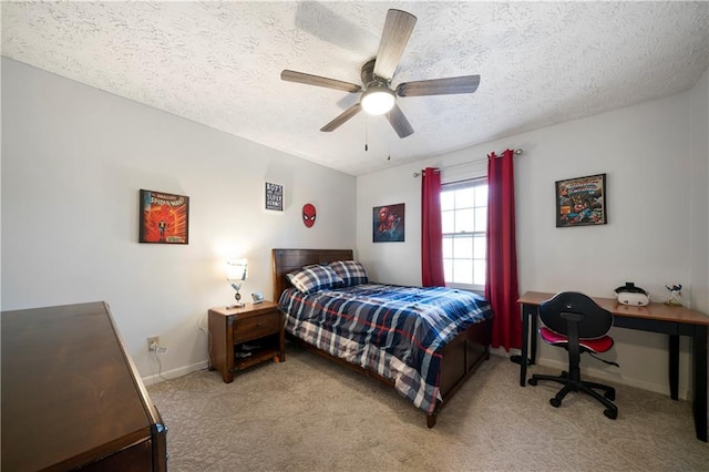 bedroom with carpet, baseboards, ceiling fan, and a textured ceiling