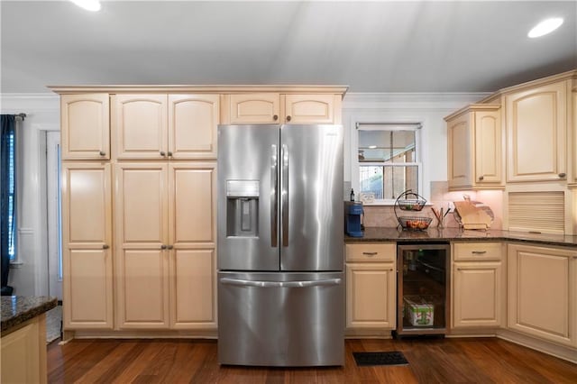 kitchen featuring wine cooler, dark wood-style flooring, ornamental molding, stainless steel fridge with ice dispenser, and dark stone countertops