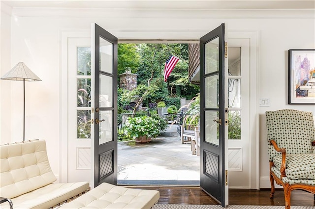 doorway to outside featuring french doors, dark hardwood / wood-style flooring, plenty of natural light, and ornamental molding