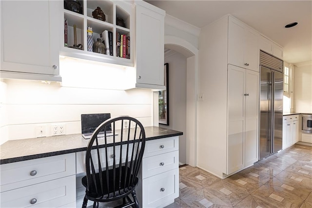 kitchen featuring white cabinets and built in refrigerator