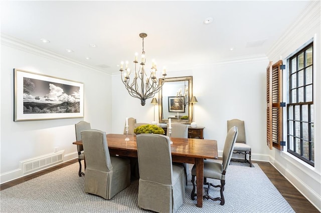 dining space with a chandelier, dark hardwood / wood-style flooring, a wealth of natural light, and ornamental molding