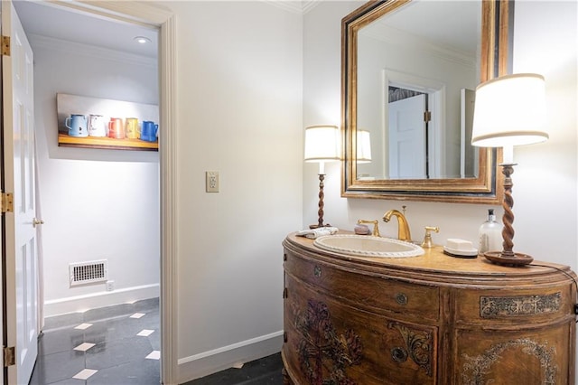 bathroom featuring crown molding and vanity