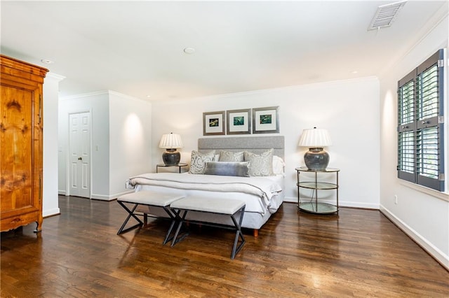 bedroom featuring dark hardwood / wood-style floors and ornamental molding