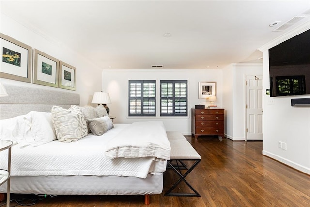 bedroom with crown molding and dark wood-type flooring