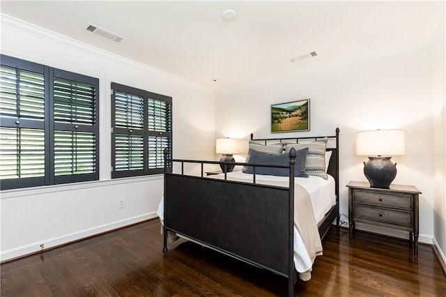 bedroom featuring ornamental molding and dark wood-type flooring