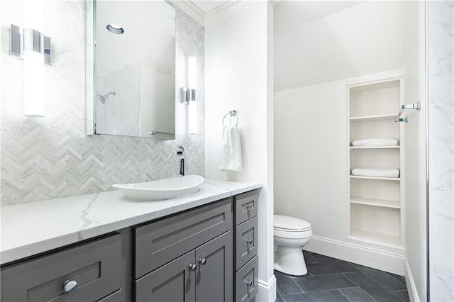 bathroom featuring vanity, tile patterned floors, decorative backsplash, toilet, and ornamental molding