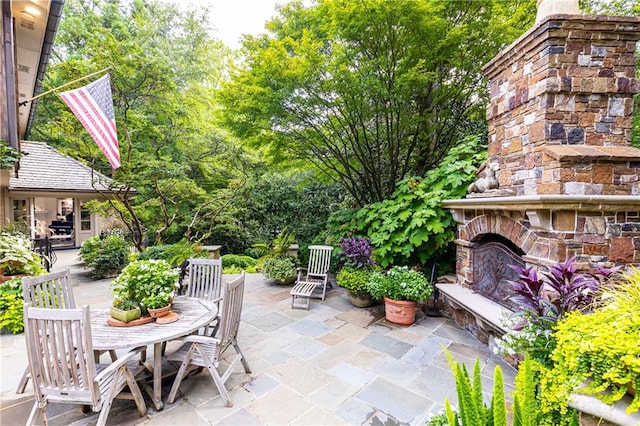 view of patio / terrace featuring an outdoor stone fireplace