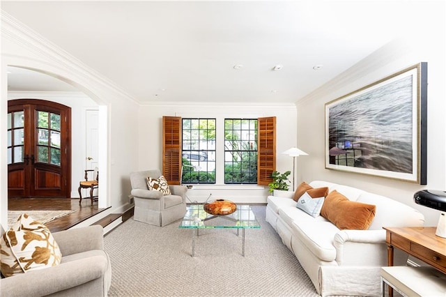 living room featuring plenty of natural light, light hardwood / wood-style floors, and crown molding