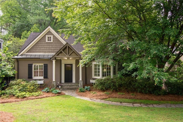 craftsman inspired home with a standing seam roof and a front yard