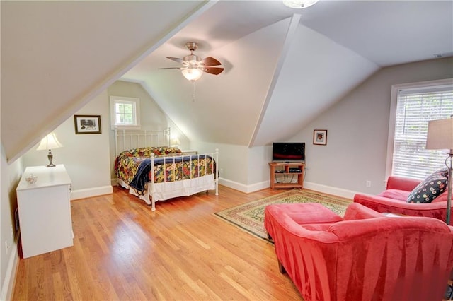bedroom with baseboards, ceiling fan, lofted ceiling, and light wood-style floors