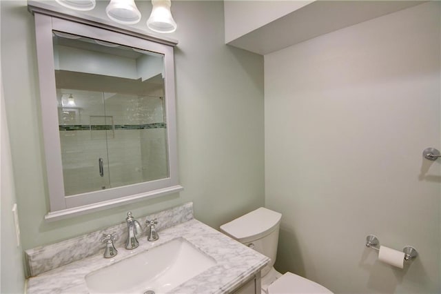 full bath featuring vanity, a shower stall, and toilet