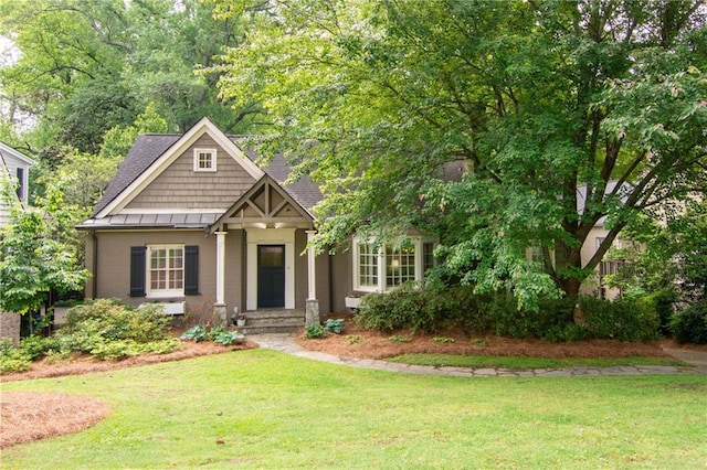 craftsman inspired home featuring a standing seam roof and a front lawn