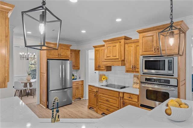 kitchen featuring tasteful backsplash, ornamental molding, decorative light fixtures, stainless steel appliances, and light wood-type flooring