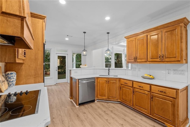 kitchen featuring dishwasher, brown cabinets, black electric stovetop, light countertops, and a sink