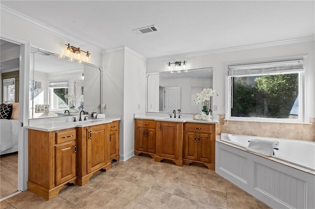 full bath featuring crown molding, two vanities, visible vents, a sink, and a bath