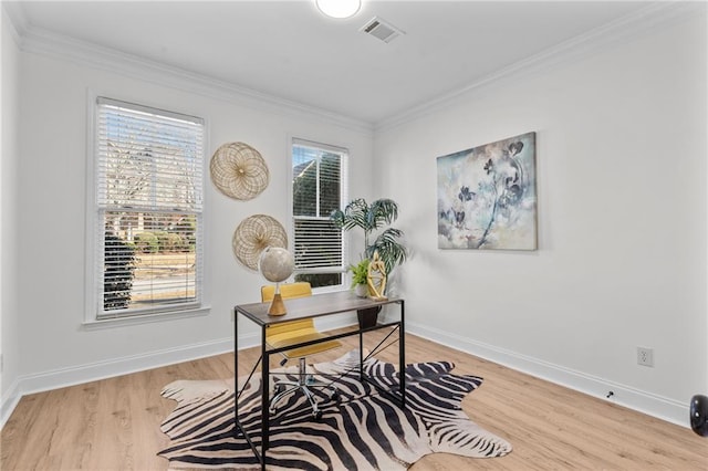 office space with crown molding, wood finished floors, visible vents, and baseboards