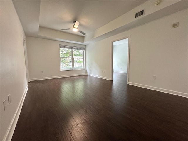 195 14th St NE Unit 303, Atlanta, GA 30309 - spare room with a tray ceiling, dark wood finished floors, and a ceiling fan