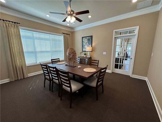 dining area with dark colored carpet, visible vents, crown molding, and baseboards