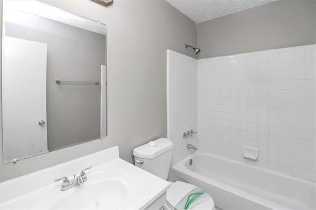 full bathroom with vanity, toilet, bathing tub / shower combination, and a textured ceiling