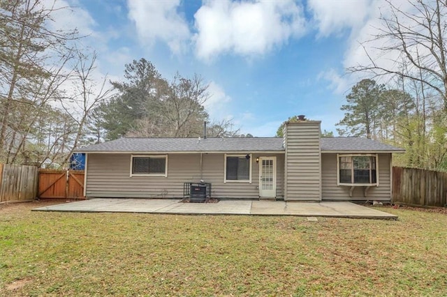 rear view of property featuring central AC, a lawn, and a patio area