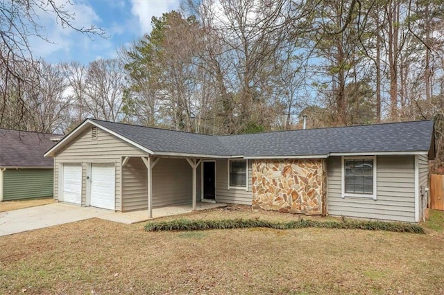 ranch-style home featuring a garage and a front yard