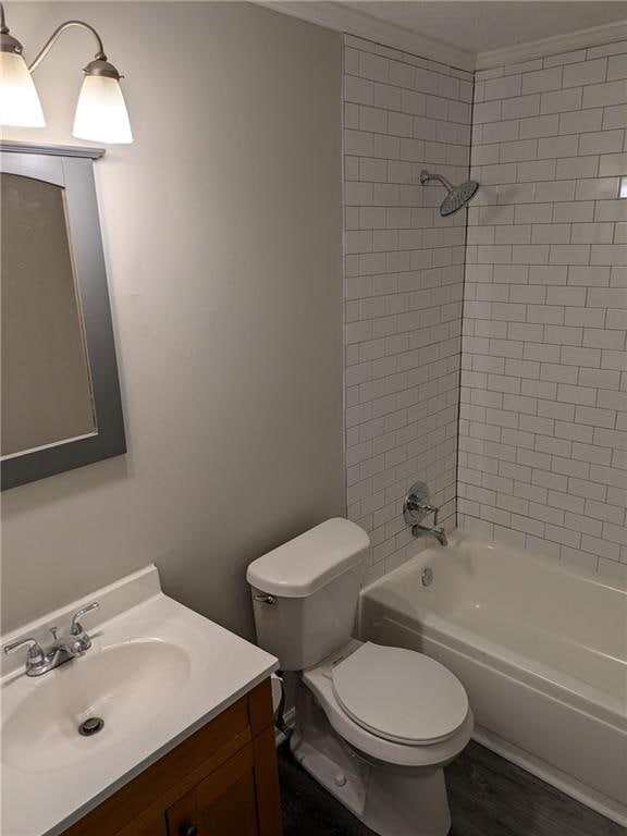 full bathroom featuring vanity, toilet, tiled shower / bath combo, and hardwood / wood-style flooring