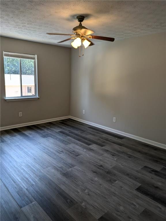 empty room featuring a textured ceiling, ceiling fan, and dark hardwood / wood-style floors