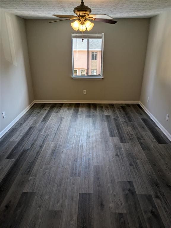 empty room featuring a textured ceiling, ceiling fan, and dark hardwood / wood-style floors