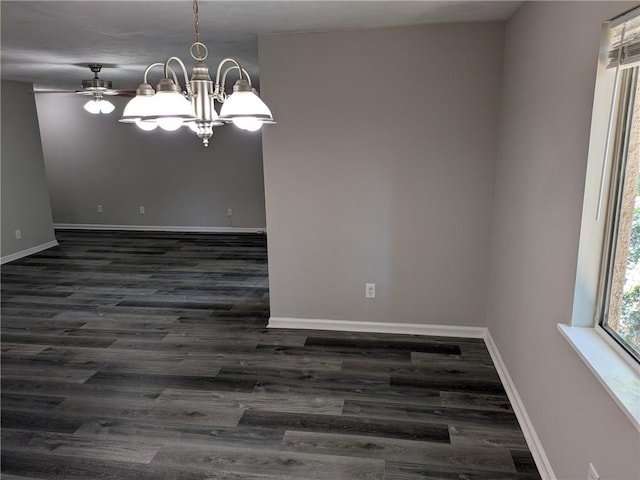 spare room featuring ceiling fan with notable chandelier and dark hardwood / wood-style flooring