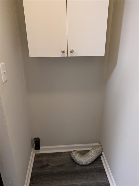 laundry room featuring cabinets and hardwood / wood-style floors