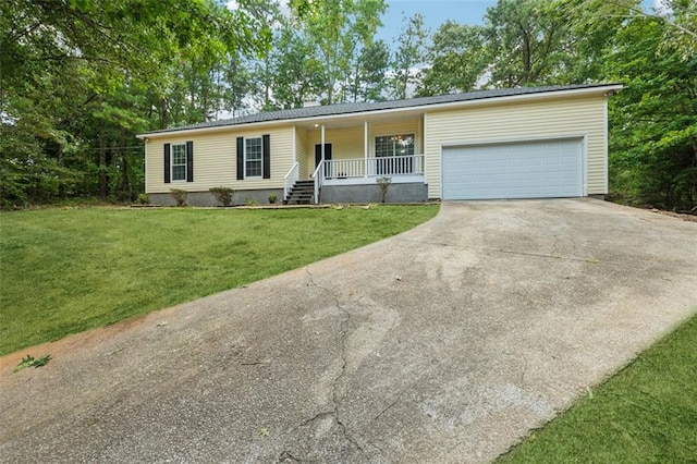 ranch-style home with covered porch, a garage, and a front yard