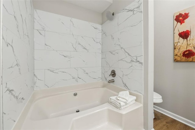 bathroom with hardwood / wood-style floors and toilet