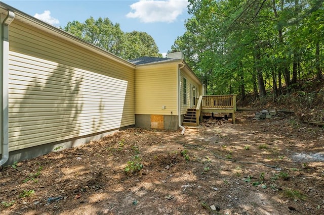 view of property exterior featuring a wooden deck