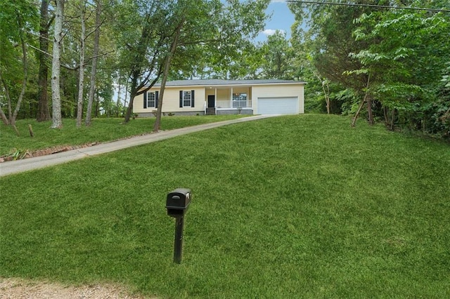 ranch-style house with covered porch, a garage, and a front yard