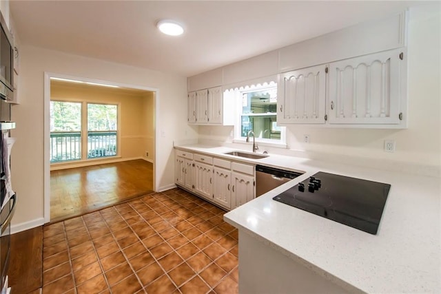 kitchen with sink, dishwasher, white cabinetry, black electric stovetop, and dark hardwood / wood-style flooring