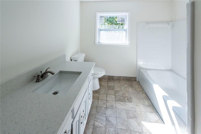 bathroom with vanity, toilet, and a bathtub