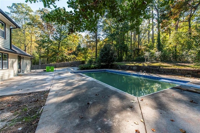 view of pool featuring a diving board and a patio area