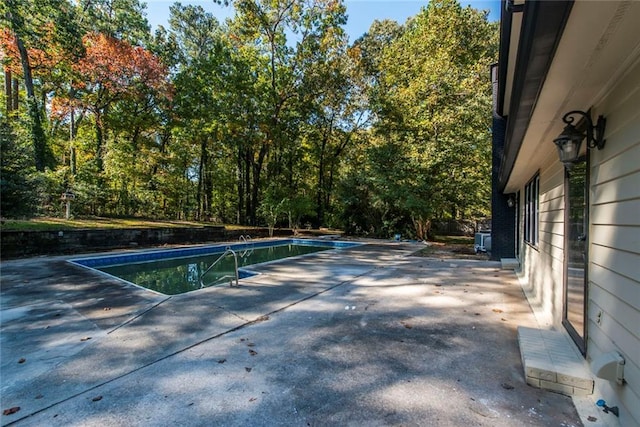 view of swimming pool featuring a patio and central AC