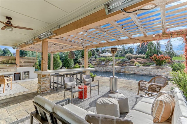 view of patio with an outdoor living space, exterior kitchen, and a bar