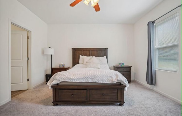 bedroom with ceiling fan, multiple windows, and light colored carpet