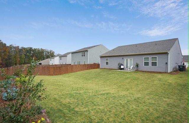 back of property with a patio and a yard