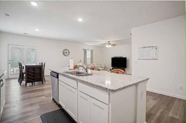 kitchen featuring white cabinetry, hardwood / wood-style floors, a center island with sink, and dishwasher