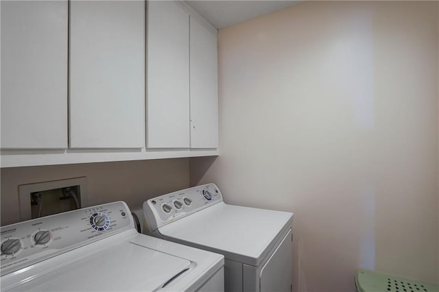 laundry room with cabinet space and washing machine and dryer