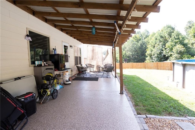 view of patio / terrace with fence and an outdoor pool