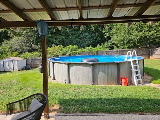 view of swimming pool with a fenced backyard, a storage shed, an outdoor structure, a yard, and a fenced in pool