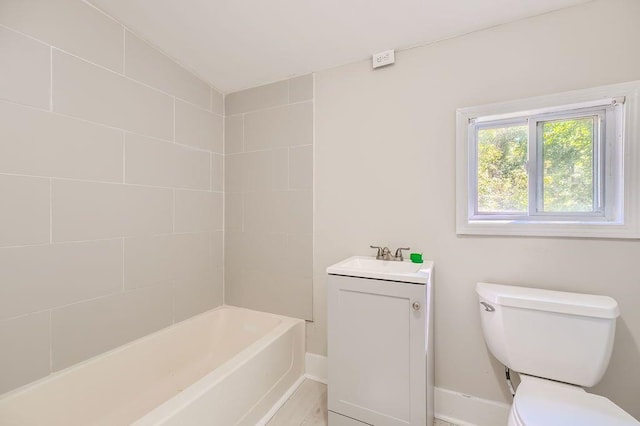 full bath with baseboards, vanity, and toilet
