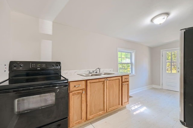kitchen with a sink, black electric range oven, vaulted ceiling, and a healthy amount of sunlight