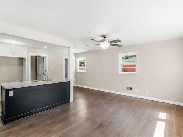 interior space featuring dark hardwood / wood-style floors, sink, and ceiling fan