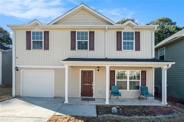 view of front of house featuring driveway, a porch, and an attached garage