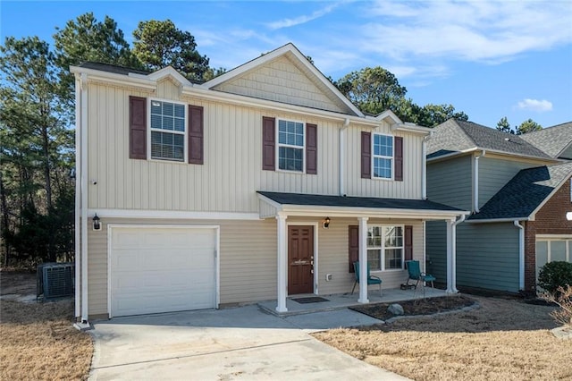 view of front facade with a garage, covered porch, central AC, and concrete driveway